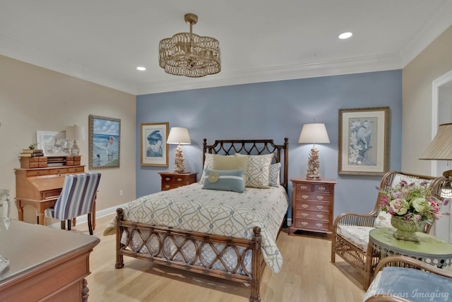 bedroom featuring crown molding, a notable chandelier, and light wood-type flooring