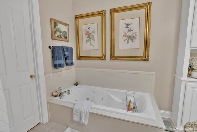 bathroom with tile patterned flooring and a tub