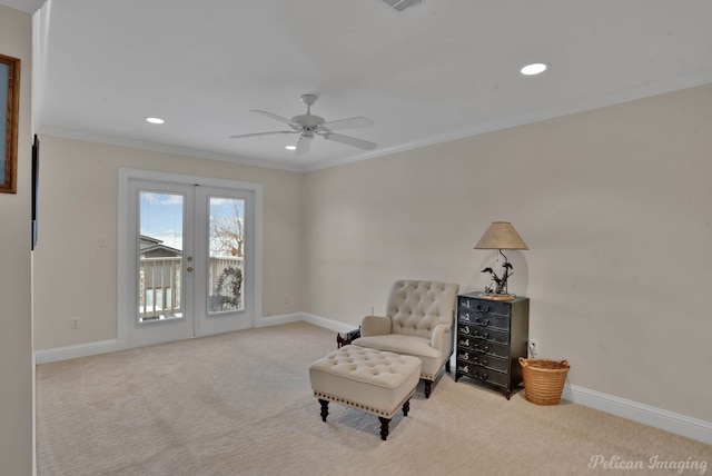 sitting room featuring crown molding, light colored carpet, french doors, and ceiling fan