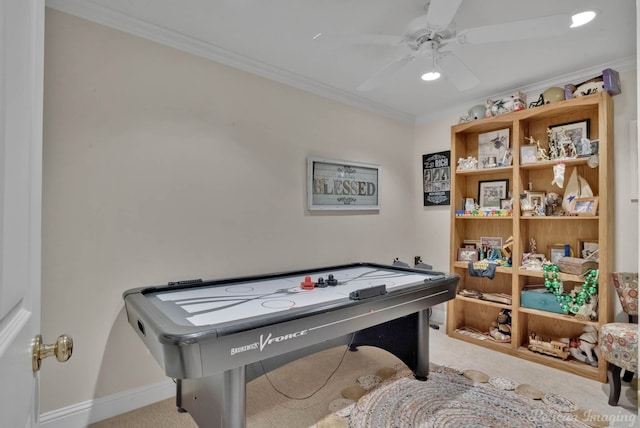 recreation room featuring crown molding, ceiling fan, and light carpet