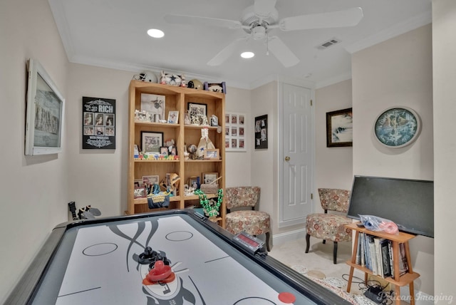 playroom with crown molding, ceiling fan, and carpet flooring