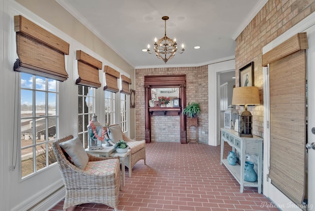 living area featuring an inviting chandelier, ornamental molding, and brick wall