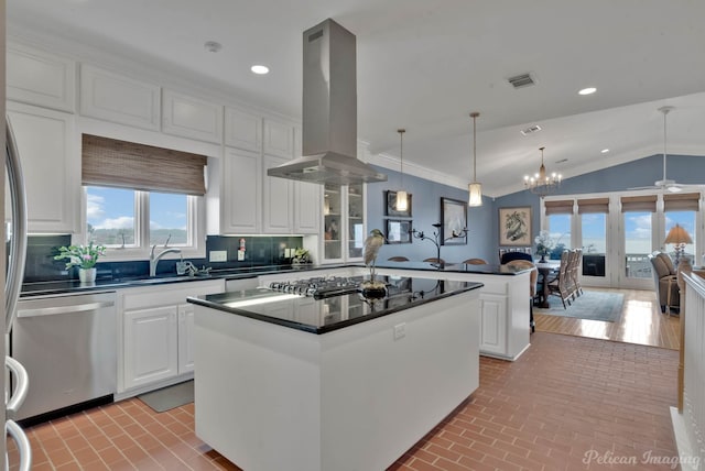 kitchen with appliances with stainless steel finishes, pendant lighting, island range hood, white cabinetry, and a center island