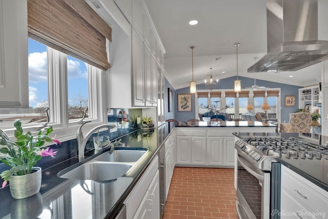 kitchen featuring sink, stainless steel appliances, island range hood, white cabinets, and kitchen peninsula