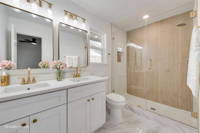 bathroom featuring vanity, an enclosed shower, and toilet