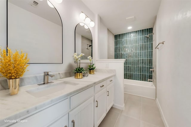 bathroom featuring tiled shower / bath combo, vanity, and tile patterned floors