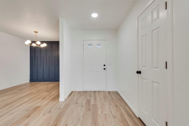 entryway featuring a chandelier and light hardwood / wood-style flooring