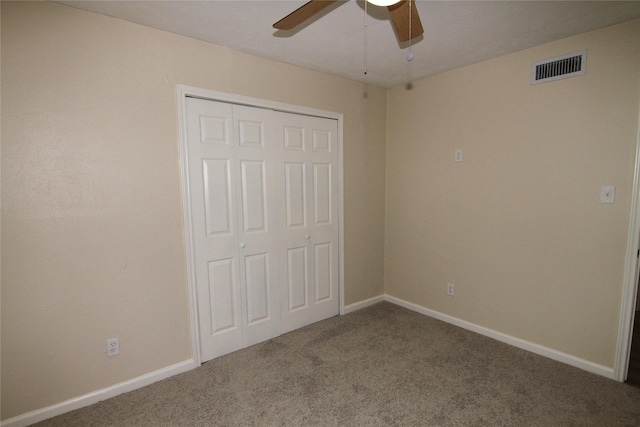 unfurnished bedroom with a closet, ceiling fan, and carpet