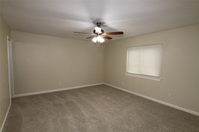 unfurnished room featuring ceiling fan and carpet