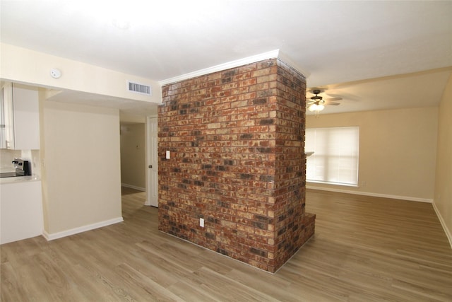 unfurnished living room featuring ceiling fan and light hardwood / wood-style flooring