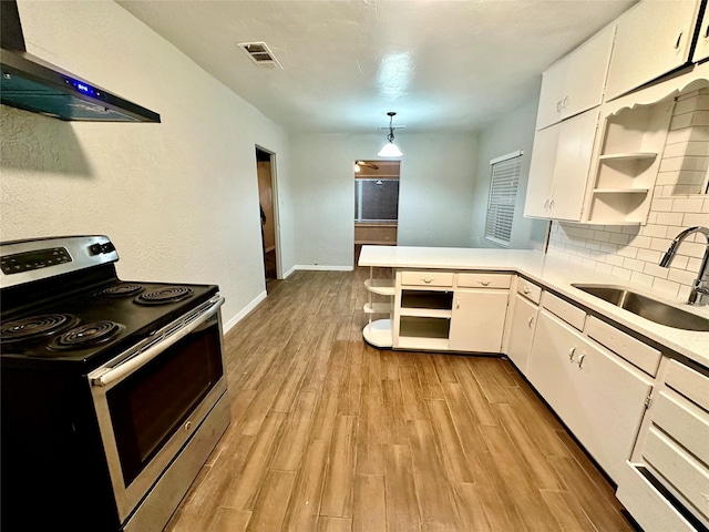 kitchen with sink, white cabinets, stainless steel electric stove, and decorative light fixtures