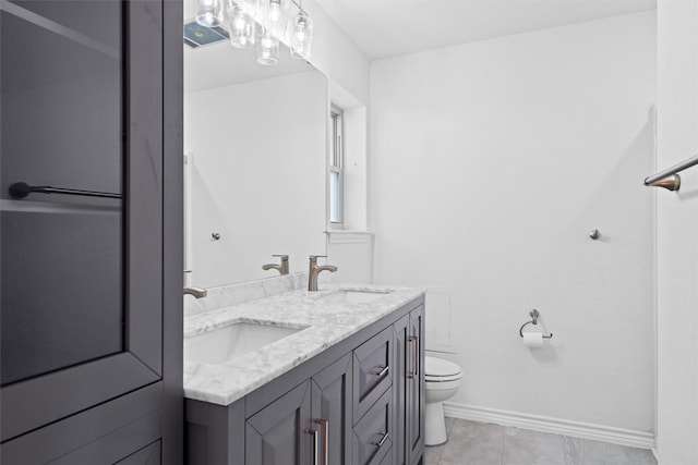 bathroom featuring tile patterned flooring, vanity, and toilet