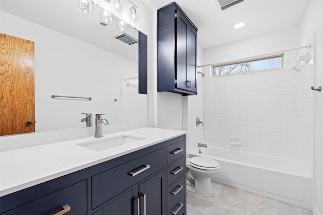 full bathroom with vanity, tiled shower / bath, tile patterned flooring, and toilet