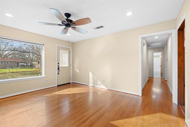 interior space featuring ceiling fan, a textured ceiling, and light wood-type flooring