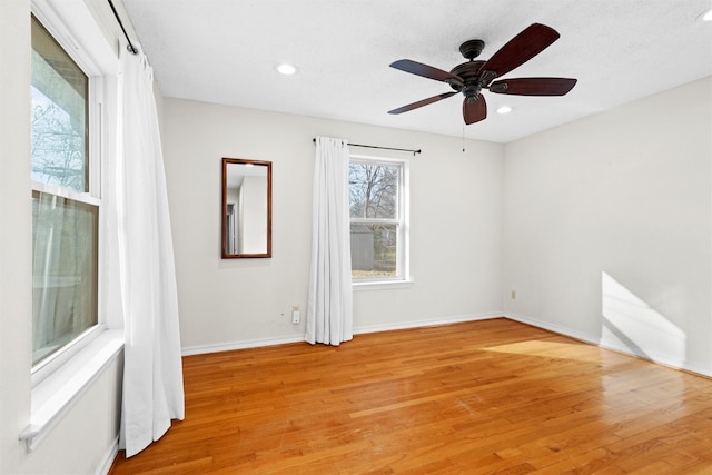 spare room featuring ceiling fan and light wood-type flooring