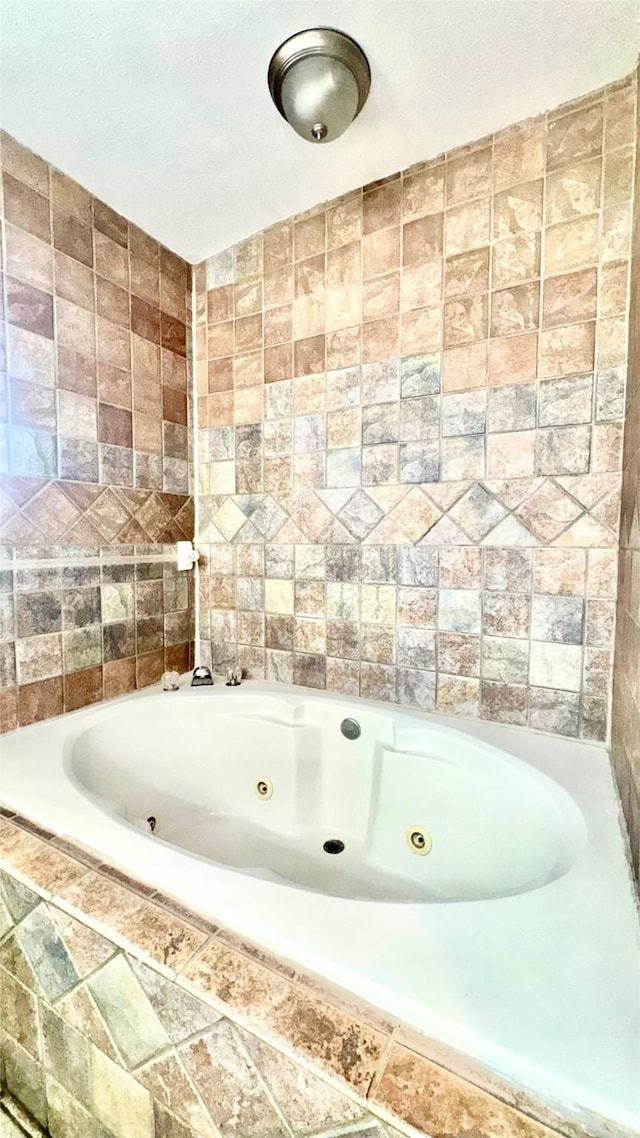 bathroom featuring a relaxing tiled tub