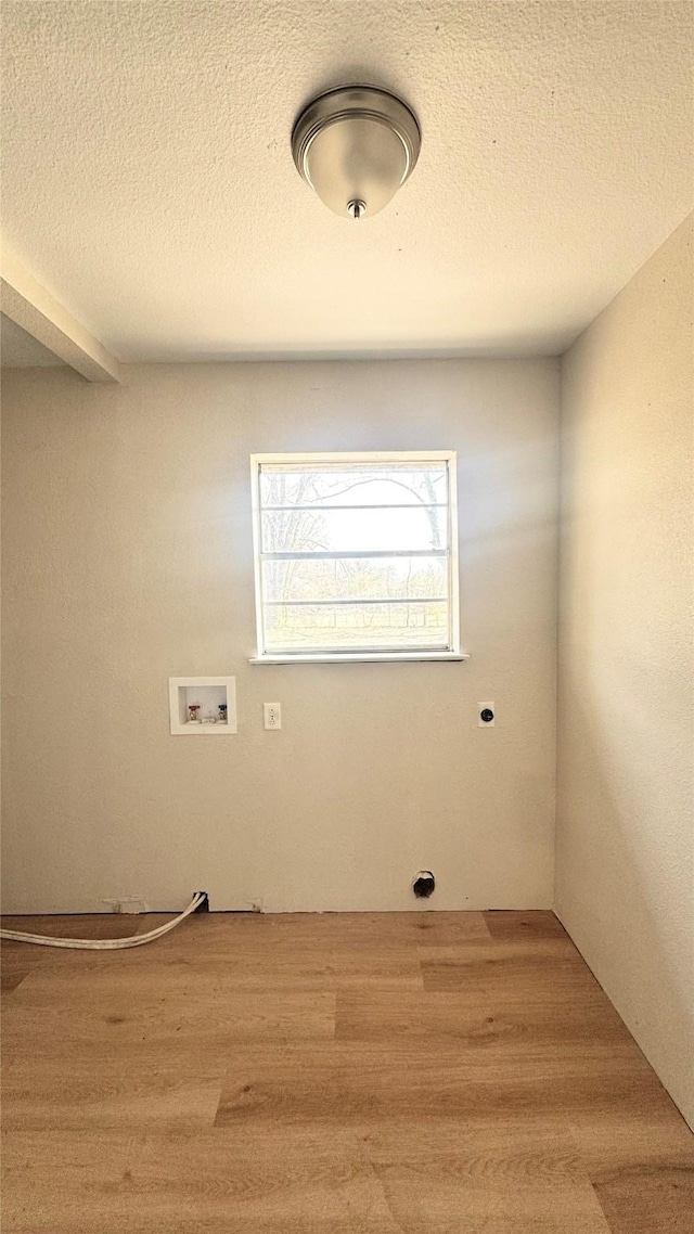 laundry area with washer hookup, hookup for an electric dryer, wood-type flooring, and a textured ceiling