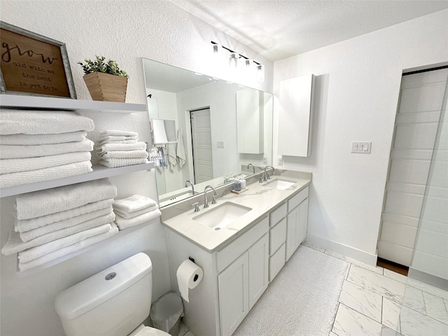 full bathroom with marble finish floor, a sink, toilet, and baseboards