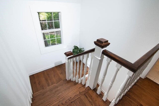 stairs featuring baseboards and wood finished floors