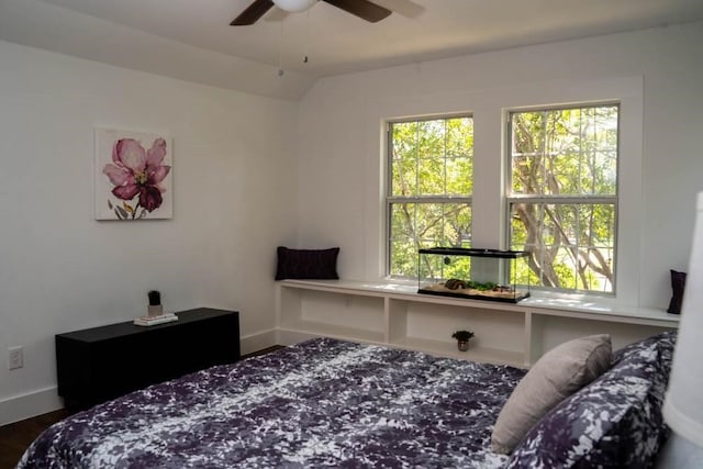 bedroom featuring vaulted ceiling, baseboards, and wood finished floors