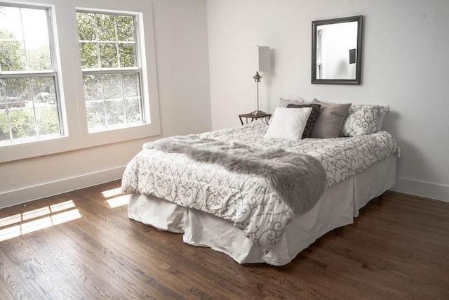 bedroom featuring dark wood-type flooring and baseboards