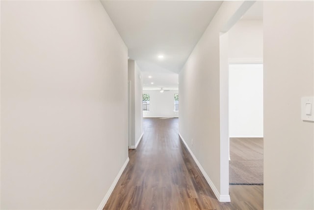 hall with recessed lighting, wood finished floors, and baseboards