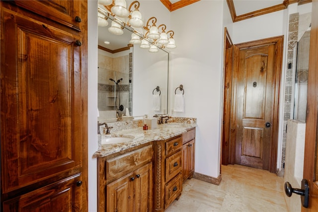 bathroom with tiled shower, ornamental molding, vanity, and a notable chandelier