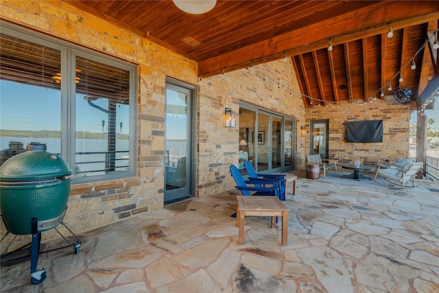 view of patio / terrace with a grill and a water view