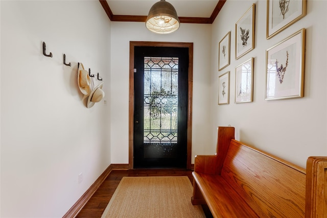 entrance foyer featuring ornamental molding and dark hardwood / wood-style floors