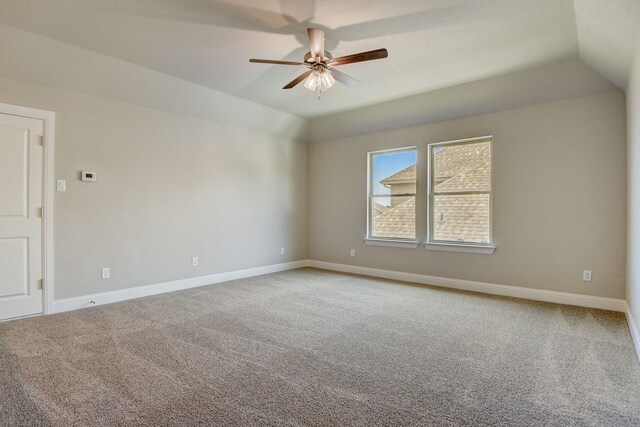 unfurnished bedroom with vaulted ceiling, light colored carpet, ceiling fan, and ensuite bathroom