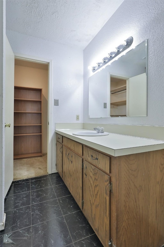 bathroom with vanity and a textured ceiling