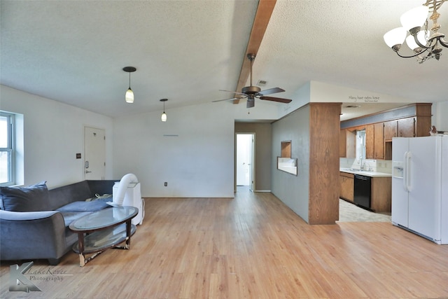 living room with ceiling fan with notable chandelier, sink, vaulted ceiling with beams, a textured ceiling, and light hardwood / wood-style flooring