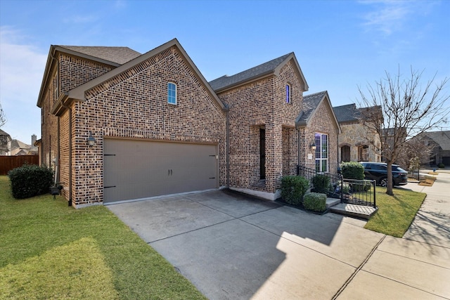 view of front of house featuring a garage, driveway, brick siding, stone siding, and a front yard