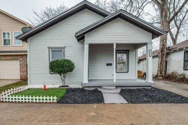 bungalow-style home featuring a garage and a porch