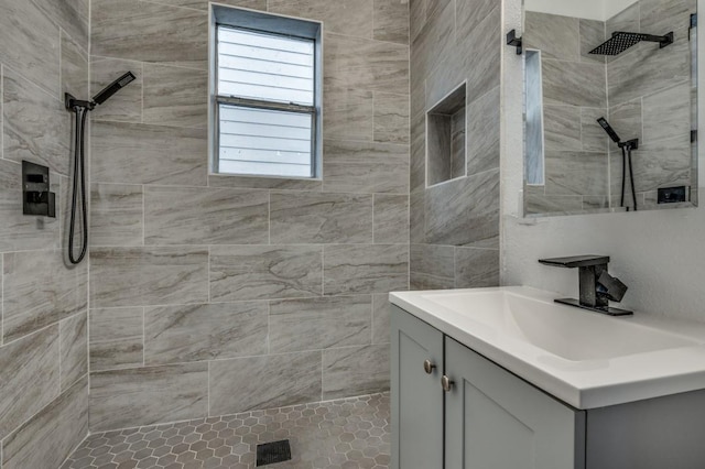 bathroom featuring vanity and a tile shower