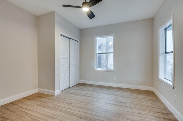 unfurnished bedroom featuring a closet, ceiling fan, and light hardwood / wood-style flooring