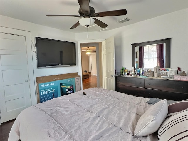 bedroom with dark wood-type flooring and ceiling fan