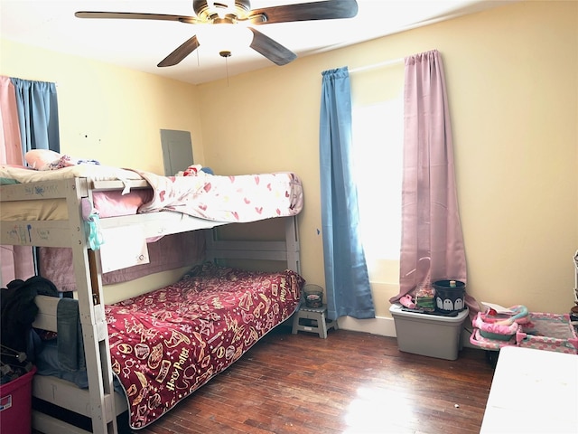 bedroom with multiple windows, dark hardwood / wood-style floors, and ceiling fan