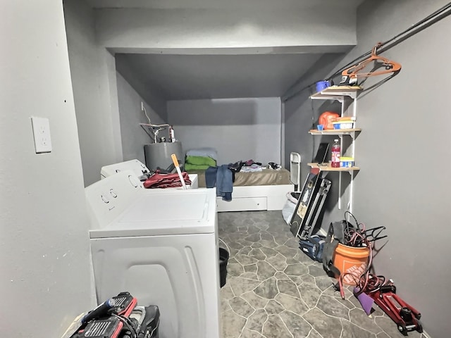 laundry area featuring water heater and washer and clothes dryer