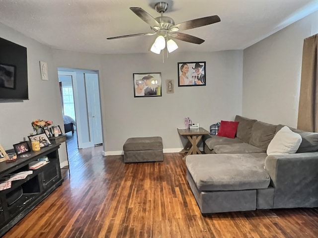 living room with dark hardwood / wood-style floors and ceiling fan