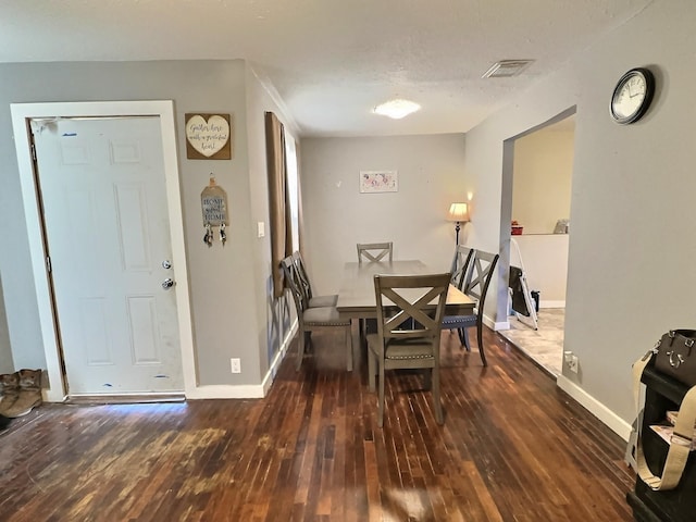 dining area with dark hardwood / wood-style flooring