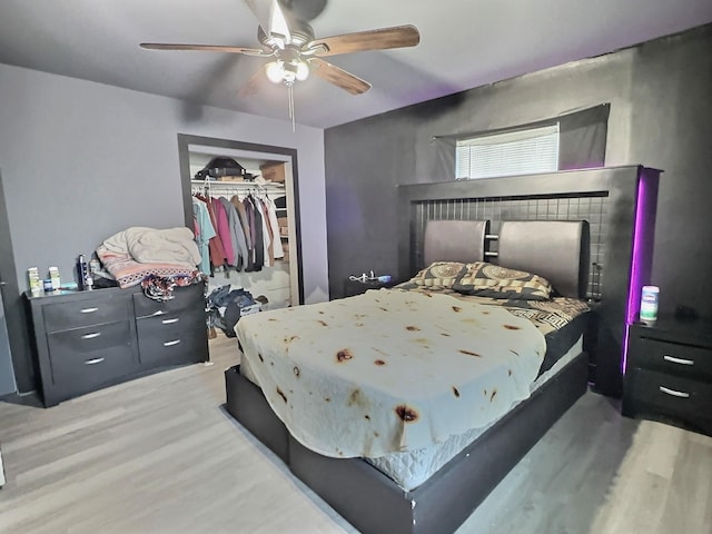 bedroom featuring wood-type flooring, a closet, and ceiling fan