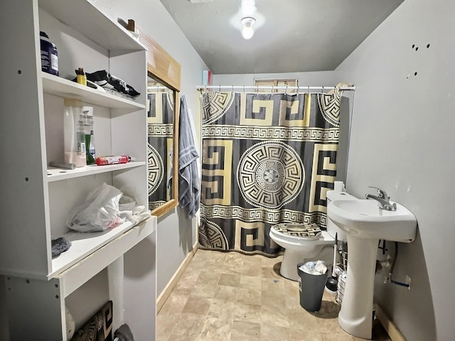 bathroom with walk in shower, toilet, and sink