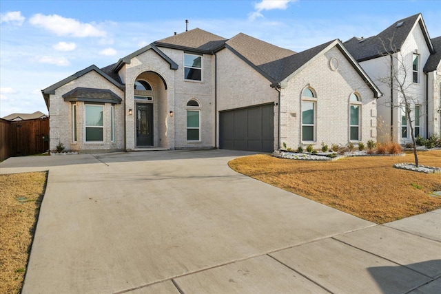 french country style house with a garage