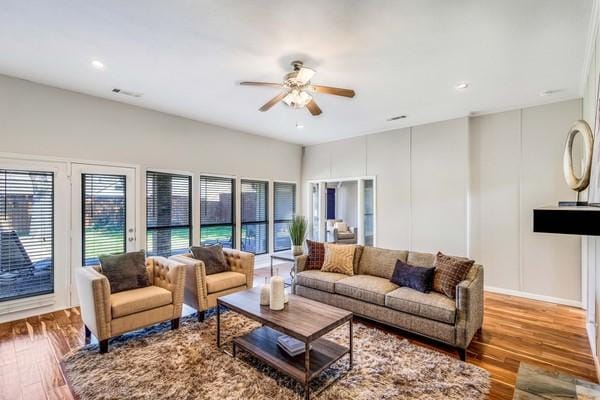 living room featuring ceiling fan and light wood-type flooring