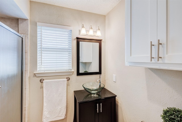 bathroom featuring vanity and an enclosed shower