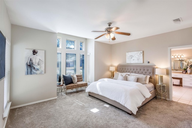 carpeted bedroom with ceiling fan and ensuite bath