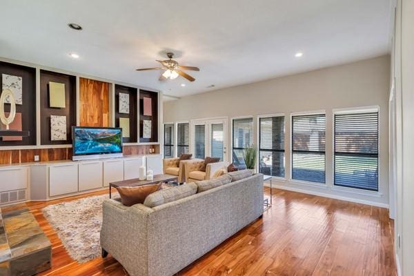 living room with ceiling fan and light wood-type flooring