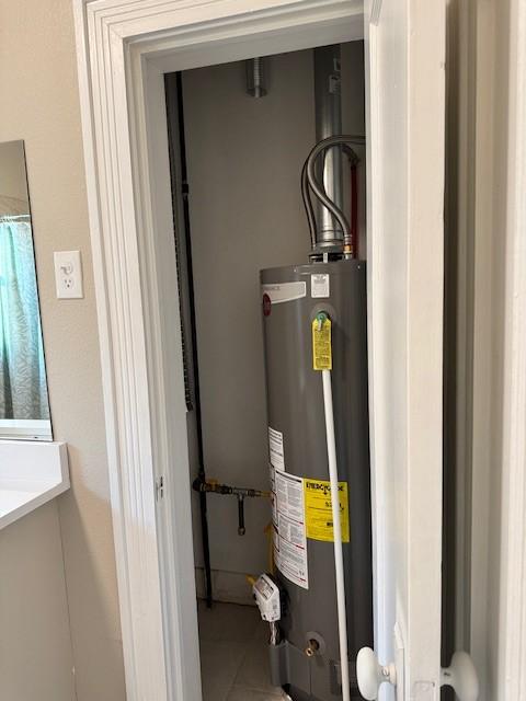 utility room featuring water heater