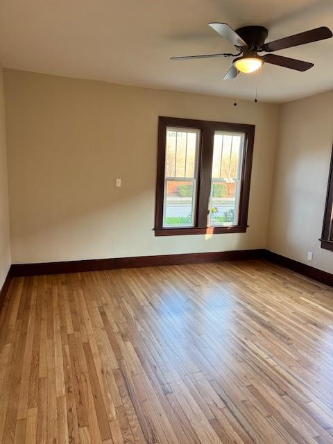 empty room featuring ceiling fan and light wood-type flooring